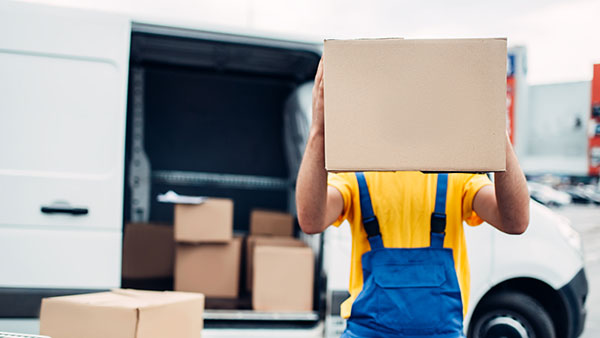 Woman carrying cardboard box